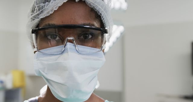 Healthcare Worker in Protective Gear Focused on Patient Care - Download Free Stock Images Pikwizard.com