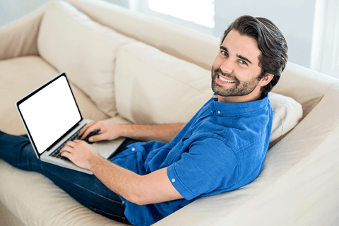 smiling man using laptop on comfortable homely sofa - Download Free Stock Videos Pikwizard.com