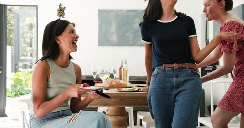 Diverse Friends Celebrate Graduation Indoors