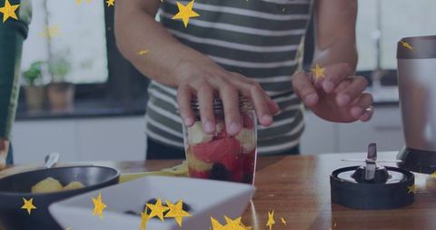 Pressing fresh fruit smoothie jar in bright home kitchen