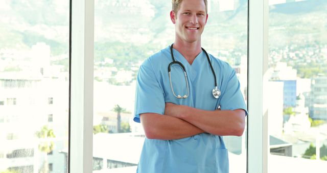 Confident Male Doctor Standing with Arms Crossed in Hospital - Download Free Stock Images Pikwizard.com