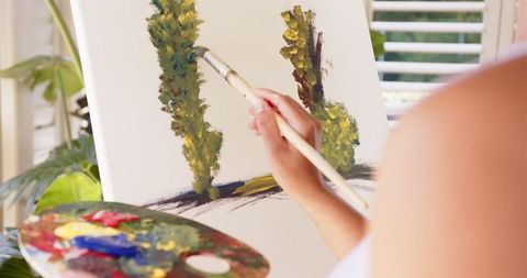 Artist Painting Trees on Canvas with Paintbrush and Palette - Download Free Stock Images Pikwizard.com