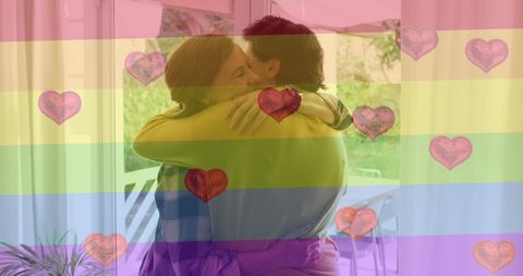 Lesbian couple embracing with rainbow flag overlay