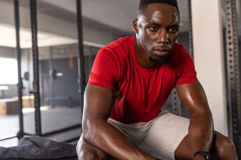 African american athlete resting after intense workout showing determination and sweat