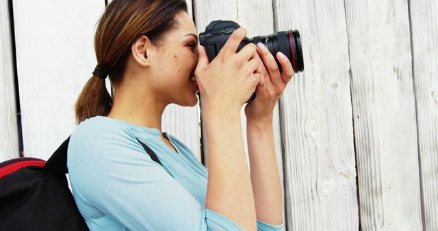 Young Woman Enthusiastically Engaged in Photography - Download Free Stock Images Pikwizard.com