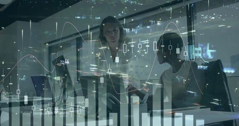 Professionals Analyzing Financial Data Late at Night in Office