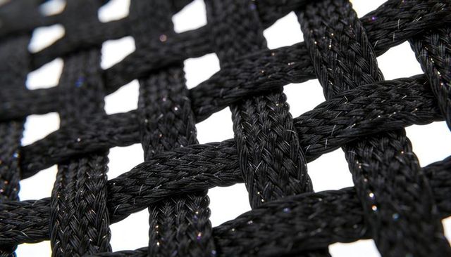Black braided cord lattice forming reflective woven grid with metallic shimmer texture