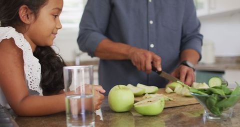 Father Teaching Daughter Cutting Green Apples in Kitchen - Download Free Stock Images Pikwizard.com