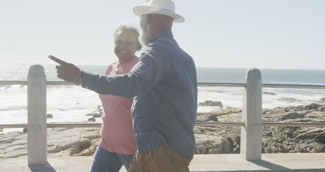 Senior Couple Enjoying Beach Stroll on Sunny Day - Download Free Stock Images Pikwizard.com