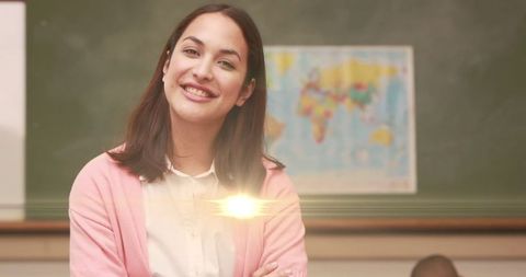 Celebratory Teacher Smiling in Classroom for World Teacher's Day