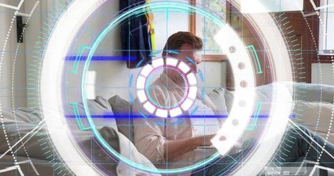 Man using tablet on living room sofa with augmented reality HUD overlay