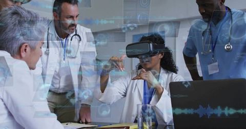 Clinician wearing VR headset demonstrating virtual anatomy with multidisciplinary team