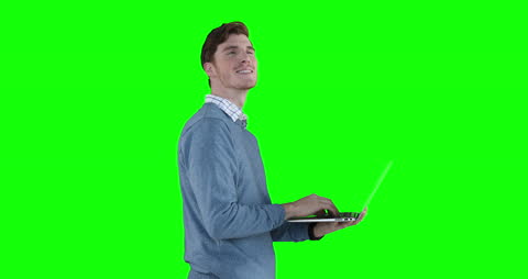 Smiling Man Using Laptop with Green Screen Background