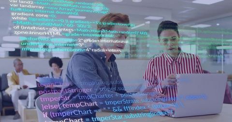 Two developers collaborating over laptop with code overlay in modern open-plan office