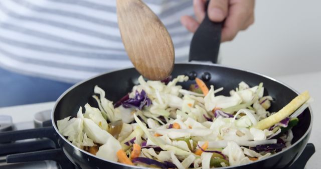 Someone Stirring Fresh Vegetable Stir-Fry in Pan on Stove - Download Free Stock Photos Pikwizard.com