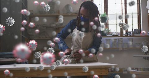 African American Woman Crafting Pottery with Virtual Virus Projections During Pandemic