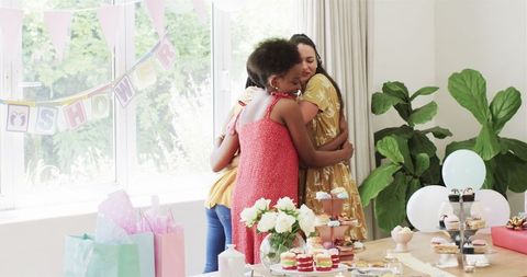 Women Celebrating Joyous Baby Shower with Gifts and Desserts