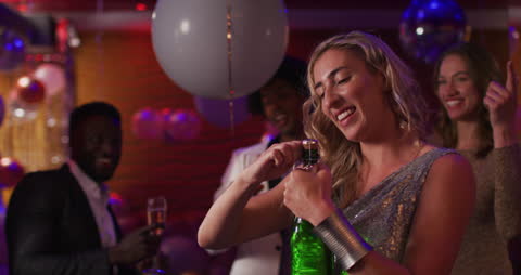 Joyful Celebration with Diverse Friends Uncorking Champagne at Nightclub