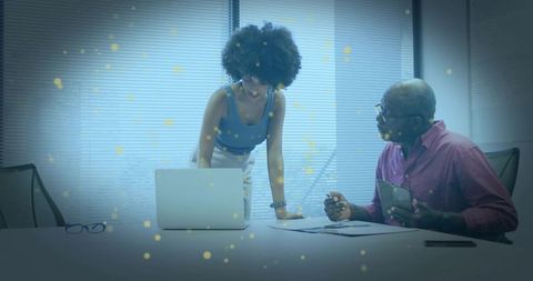 Young professional presenting to senior colleague during collaborative mentorship meeting