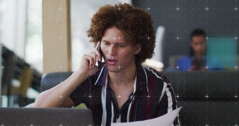 Focused biracial professional working in modern office