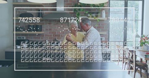Senior couple dancing beside kitchen island with augmented reality interface overlay