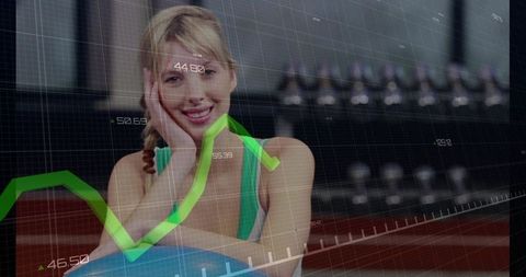 Smiling woman resting on exercise ball with fitness analytics overlay