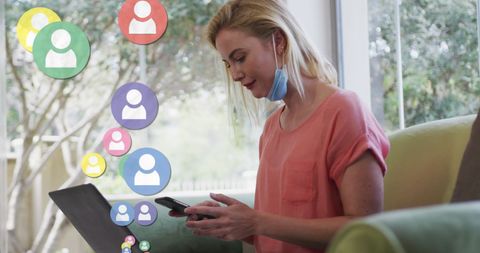 Caucasian Woman Multitasking with Smartphone and Laptop