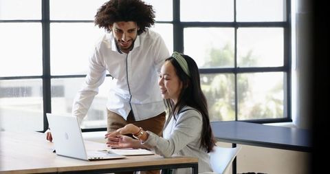 Diverse Male and Female Colleague Collaborating in Modern Office
