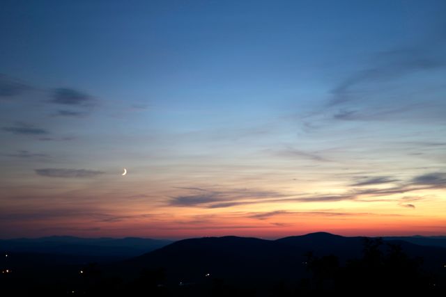 Peaceful Twilight with Crescent Moon over Serene Hills - Download Free Stock Photos Pikwizard.com