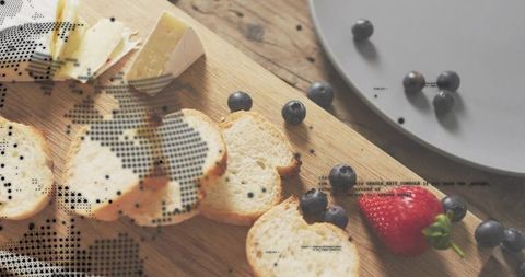 Rustic breakfast board featuring sliced baguette, brie cheese, blueberries and strawberry