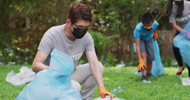 Volunteers Picking Up Trash in Park with Blue Bags - Download Free Stock Images Pikwizard.com