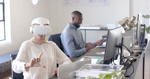 Office Team Using VR and Tablet Technology Stimulating Creativity