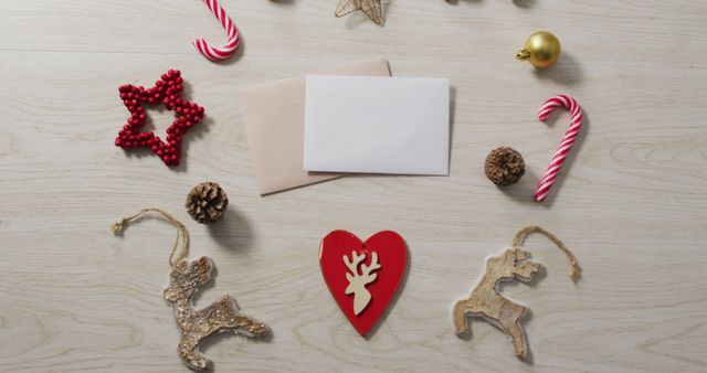 Image of christmas decorations with white and beige card on wooden background - Download Free Stock Photos Pikwizard.com