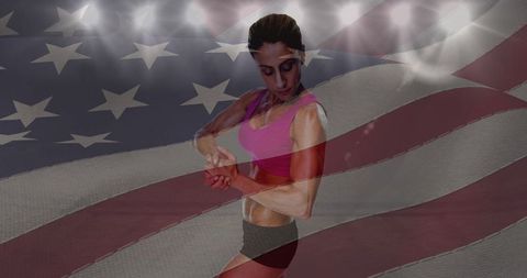 Determined female athlete with american flag in stadium ambience