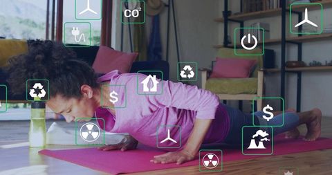 Woman performing push-ups at home with augmented reality fitness icons overlay for wellness tech