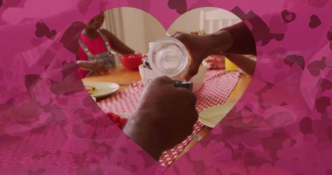 Pouring milk at family breakfast with heart overlay