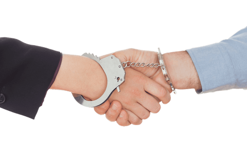 Business hands shaking in handcuffs symbolizing trust and constraint