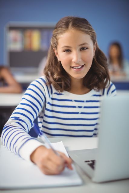 Smiling Student Studying in Classroom with Laptop - Download Free Stock Images Pikwizard.com