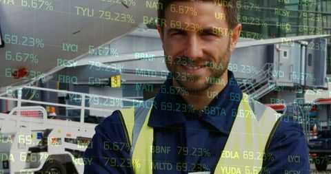 Smiling Worker Analyzing Financial Data in Factory Environment
