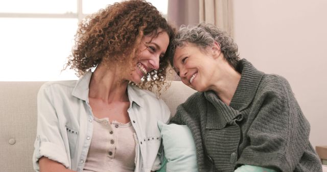 Cheerful Adult Daughter and Senior Mother Sharing a Moment on Sofa - Download Free Stock Images Pikwizard.com