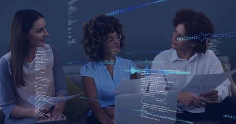 Diverse Team Brainstorming with Digital Interfaces in Modern Office