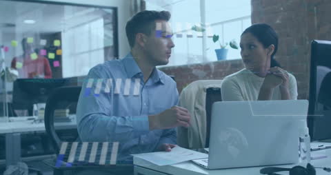 Diverse Colleagues Analyzing Financial Data on Laptop at Office