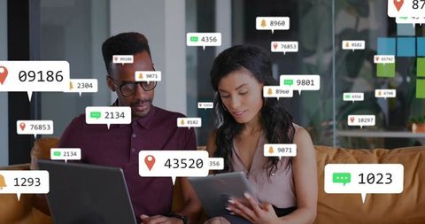 Collaborating with real-time notifications on tablet and laptop in modern open-plan lounge