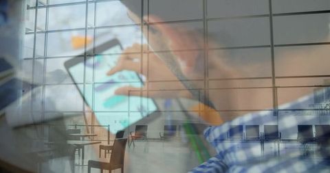 Traveler Using Tablet in Glass Concourse with Reflections, Empty Seats and Tech Interaction