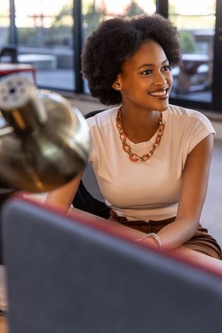 Professional Woman Engaging in Modern Workspace Discussion