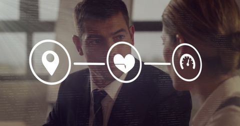 Colleagues Connecting With Digital Interface Icons in Business Meeting