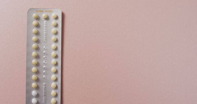 Image of close up of yellow tablets on pink background. global medicine and healthcare concept.