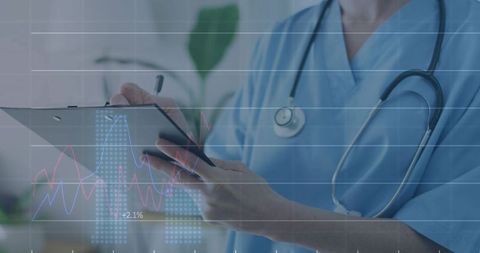 Female clinician holding tablet and reviewing healthcare analytics and monitoring charts