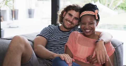 Diverse Couple Smiling on Sofa at Home - Download Free Stock Images Pikwizard.com