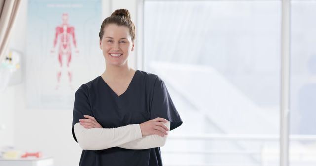 Smiling Nurse Standing in Medical Office with Arms Crossed - Download Free Stock Images Pikwizard.com